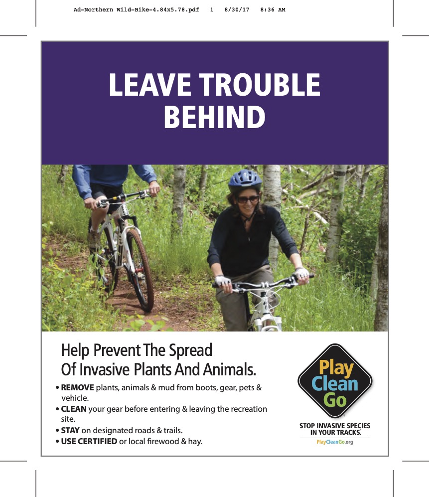 cyclists on trail with "leave trouble behind" on purple