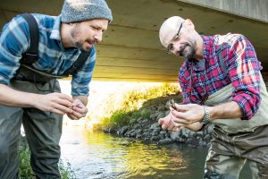 Eric Larson, left, and Christopher Taylor inspect a captured crayfish.