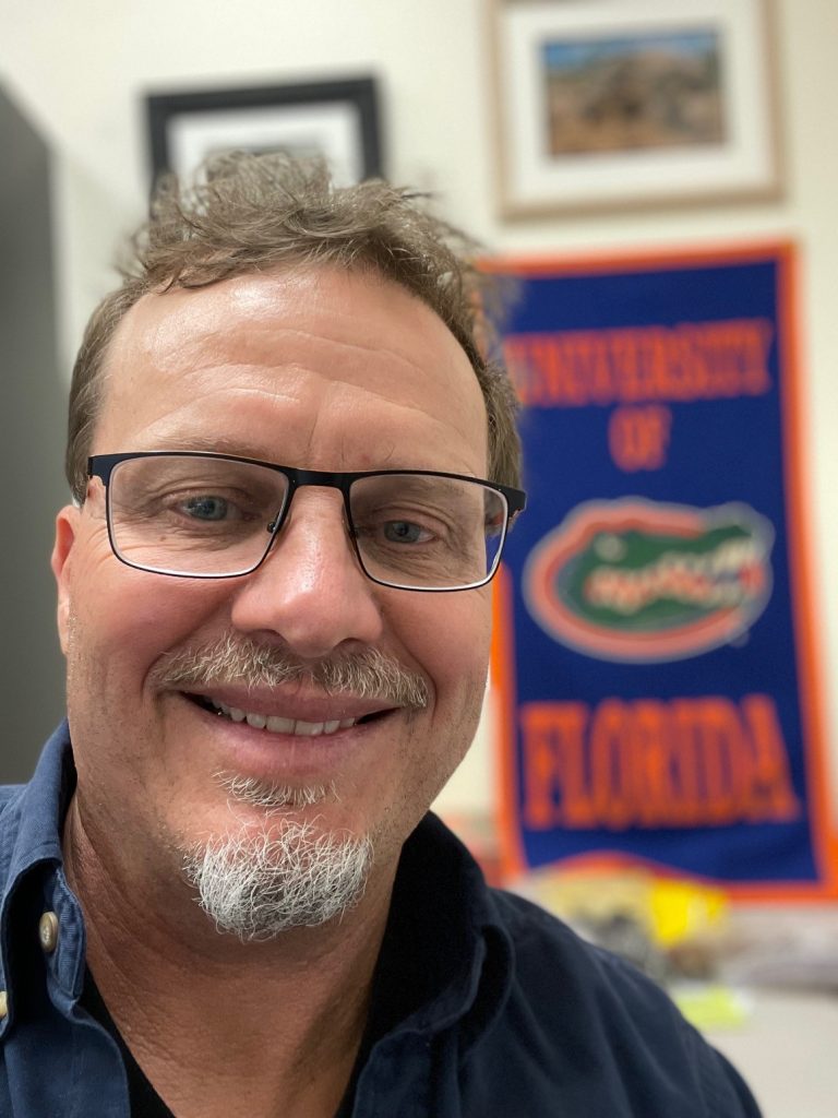 Steve A. Johnson portrait with University of Florida flag in the back